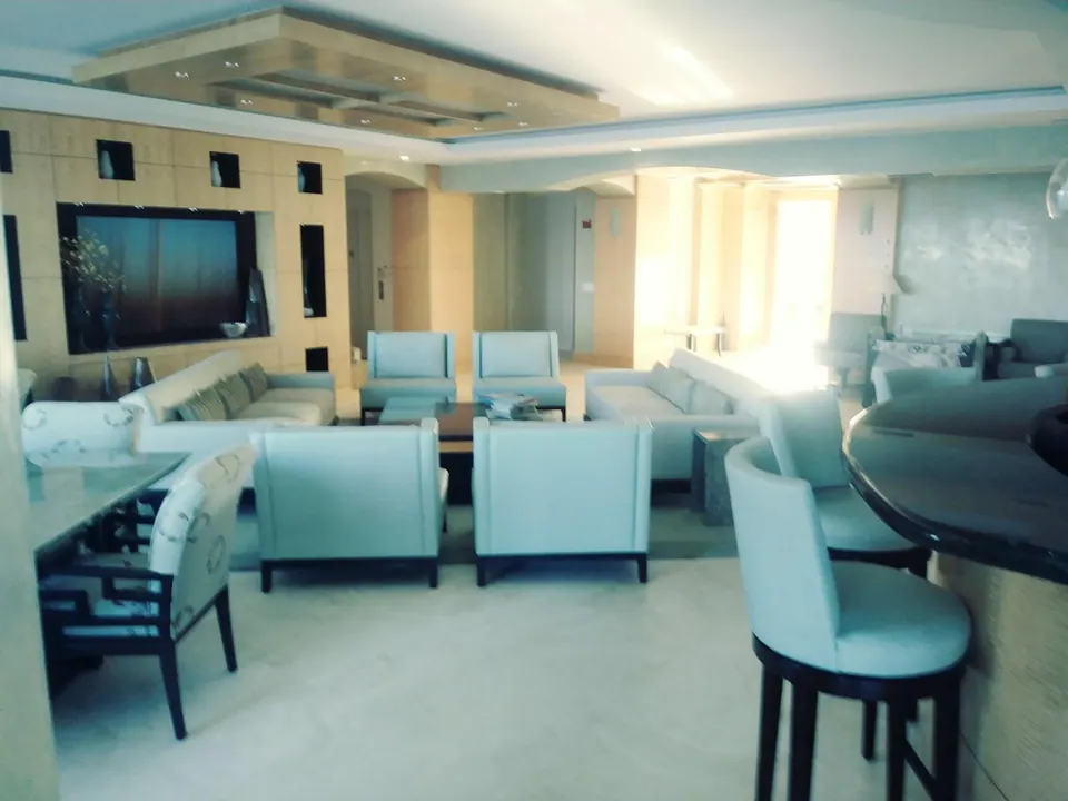 Freshly painted living area with teal accent seating